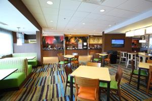 a restaurant with tables and chairs and a bar at Fairfield Inn & Suites by Marriott East Grand Forks in East Grand Forks