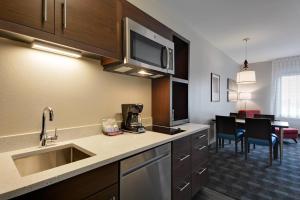 a kitchen with a sink and a counter top at TownePlace Suites by Marriott Detroit Allen Park in Allen Park