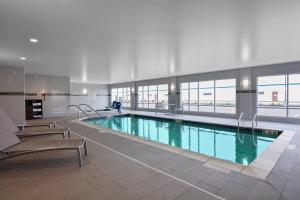 a large swimming pool in a large building at TownePlace Suites by Marriott Detroit Allen Park in Allen Park