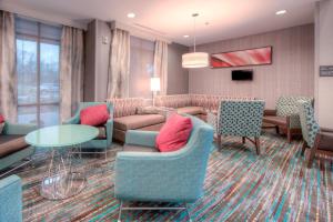 a waiting room with couches and chairs and a table at Residence Inn by Marriott Charlotte Airport in Charlotte