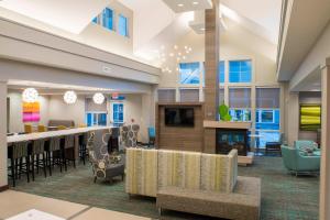 a large lobby with a bar and a fireplace at Residence Inn by Marriott Albany Clifton Park in Clifton Park