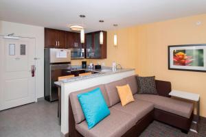 a living room with a couch and a kitchen at Residence Inn by Marriott Albany Clifton Park in Clifton Park