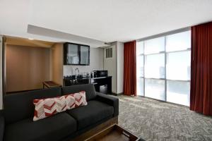 a living room with a couch and a kitchen at SpringHill Suites by Marriott Indianapolis Airport/Plainfield in Plainfield