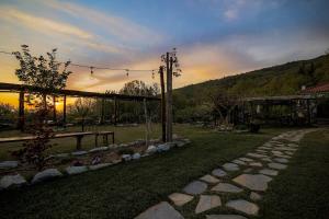 a garden with a picnic table and a stone path at Farmhouse Karaiskos in Portaria