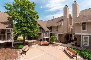 a courtyard with two benches and a tree at Residence Inn Chicago Deerfield in Deerfield