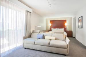 a living room with a couch and a bed at Residence Inn Chicago Deerfield in Deerfield