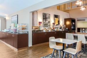 a kitchen with a table and chairs and a counter at Residence Inn Chicago Deerfield in Deerfield