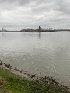 a large body of water with a city in the background at David’s apartment in London