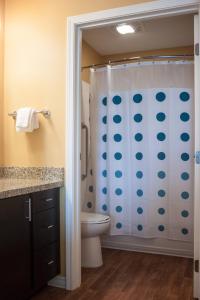 a bathroom with a shower and a toilet at TownePlace Suites by Marriott Beaumont Port Arthur in Port Arthur