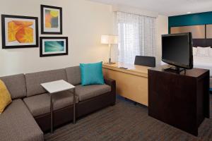 a living room with a couch and a flat screen tv at Residence Inn Denver Tech Center in Greenwood Village