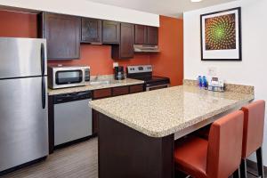 a kitchen with a refrigerator and a counter top at Residence Inn Denver Tech Center in Greenwood Village