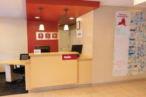 a lobby with a halo sign on a counter at TownePlace Suites Republic Airport Long Island Farmingdale in Farmingdale