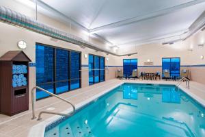 a large indoor pool with blue water in a building at TownePlace Suites by Marriott Billings in Billings