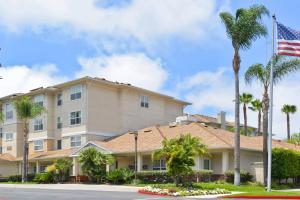 a hotel with palm trees and an american flag at Residence Inn Los Angeles LAX/El Segundo in El Segundo