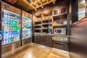 a kitchen with an open refrigerator with drinks at Courtyard Dallas DFW Airport South/Irving in Irving