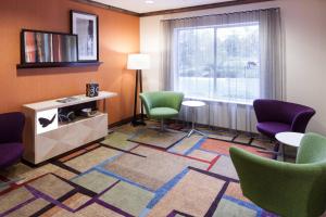 a waiting room with chairs and a table and a window at Fairfield by Marriott Ruston in Ruston