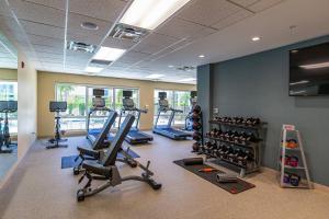 a gym with treadmills and exercise equipment in a building at TownePlace Suites Naples in Naples