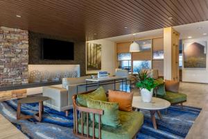 a living room with a couch and a table at Fairfield by Marriott Inn & Suites Sandusky in Sandusky