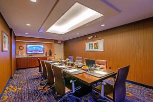 a conference room with a long table and chairs at Courtyard by Marriott Frederick in Frederick