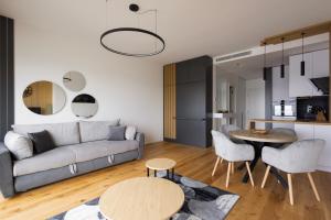 - un salon avec un canapé et une table dans l'établissement In The Sky - Apartment West 65 Tower, à Belgrade