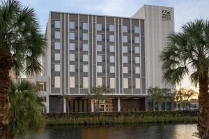 un edificio con palmeras frente a un río en AC Hotel by Marriott Miami Dadeland, en Miami