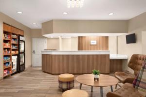 a lobby with a waiting area with a table and chairs at Residence Inn Atlanta Gwinnett Place in Duluth