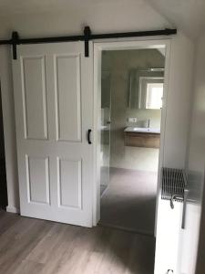 a white door in a room with a kitchen at byTilch in Borgercompagnie