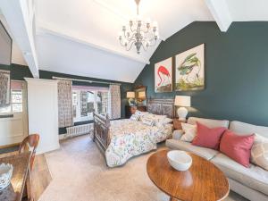 a living room with a couch and a table at Prospect Cottage Loft in Ambleside