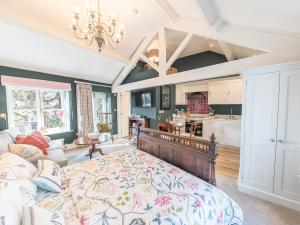a bedroom with a bed and a living room at Prospect Cottage Loft in Ambleside