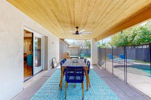 a dining room with a table and chairs on a patio at Piestewa Getaway in Phoenix