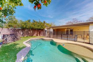 a swimming pool in the backyard of a house at Piestewa Getaway in Phoenix