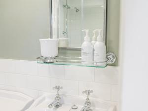 a bathroom with two sinks and a mirror at Prospect Cottage Studio in Ambleside