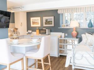 a kitchen with a table and chairs and a microwave at Prospect Cottage Studio in Ambleside