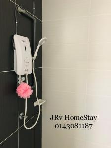 a hair dryer on the wall of a bathroom at JRv HotelStyle HomeStay Melaka in Malacca