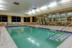 a swimming pool with blue water in a building at Macon Marriott City Center in Macon