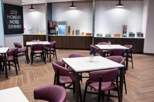 a dining room with tables and purple chairs at Fairfield Inn & Suites by Marriott Davenport Quad Cities in Davenport