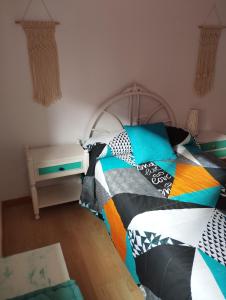 a bedroom with a bed with a colorful blanket at Home St Nicolas Home VUT42/000161 in Soria