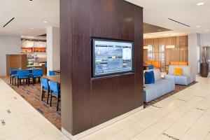 a living room with a tv on a wall at Courtyard by Marriott Paso Robles in Paso Robles