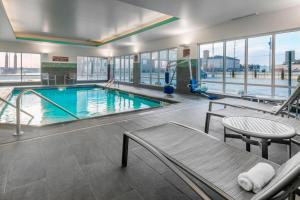 a large swimming pool in a building with a large window at Towneplace Suites By Marriott Hays in Hays