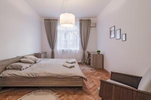 a bedroom with a large bed and a window at Lovely Art apartment - Victory in Varna City