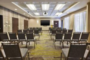 a conference room with chairs and a projection screen at Courtyard by Marriott Secaucus Meadowlands in Secaucus