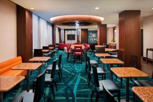 a bar with tables and chairs in a restaurant at SpringHill Suites by Marriott Houston Downtown/Convention Center in Houston