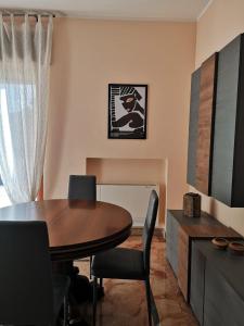 a dining room with a wooden table and chairs at Mare qui in Gaeta