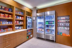 a kitchen with two refrigerators and lots of food at SpringHill Suites by Marriott Salt Lake City-South Jordan in South Jordan