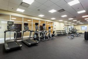 a gym with several treadmills and elliptical machines at Courtyard by Marriott Montreal West Island/Baie D’Urfe in Baie-dʼUrfé