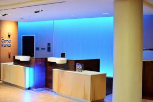 a lobby with two reception desks in a building at Fairfield Inn & Suites by Marriott Omaha Northwest in Omaha