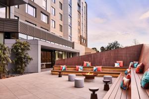 a patio with benches and a fire pit at AC Hotel by Marriott Sunnyvale Moffett Park in Sunnyvale