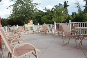 a row of chairs and tables on a patio at Fairfield Inn & Suites High Point Archdale in Archdale