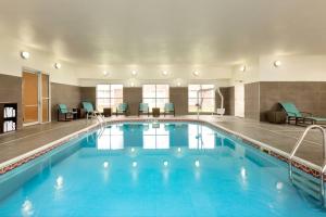 a large pool in a hotel with blue water at Residence Inn by Marriott Lubbock-University Area in Lubbock