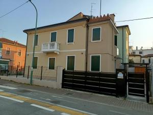 a house with a fence on the side of a street at Arcobaleno Rooms Mestre-Venezia in Mestre